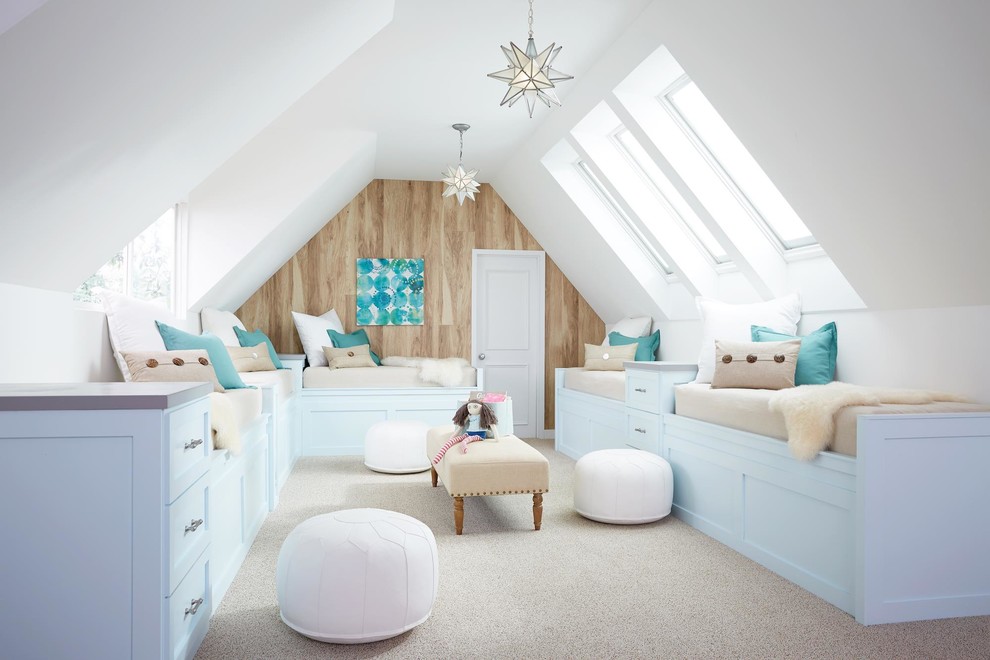 Design ideas for a beach style kids' bedroom for kids 4-10 years old and girls in Portland Maine with carpet and beige floor.