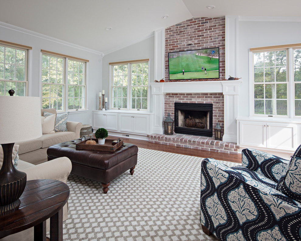 Photo of a mid-sized contemporary open concept family room in New York with a library, white walls, carpet, a brick fireplace surround, a built-in media wall, a standard fireplace and multi-coloured floor.
