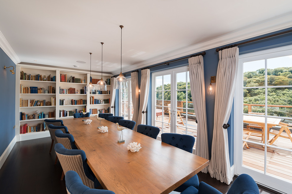 Inspiration for a beach style dining room in Devon with blue walls and dark hardwood floors.