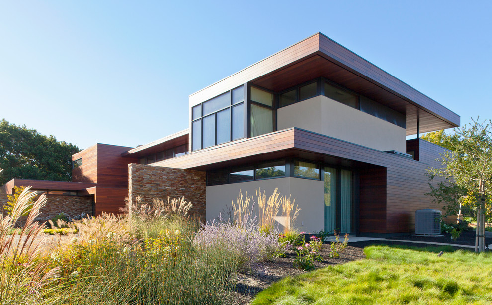 Design ideas for a large contemporary two-storey exterior in San Francisco with a flat roof and mixed siding.