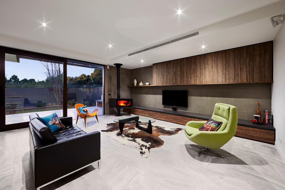 This is an example of a mid-sized modern open concept living room in Melbourne with grey walls, porcelain floors, a hanging fireplace and a wall-mounted tv.