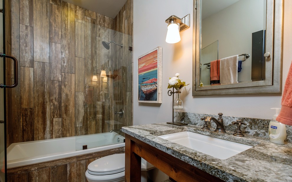Inspiration for a mid-sized traditional kids bathroom in Other with open cabinets, medium wood cabinets, a drop-in tub, a shower/bathtub combo, a one-piece toilet, gray tile, grey walls, ceramic floors, engineered quartz benchtops, multi-coloured floor and an open shower.