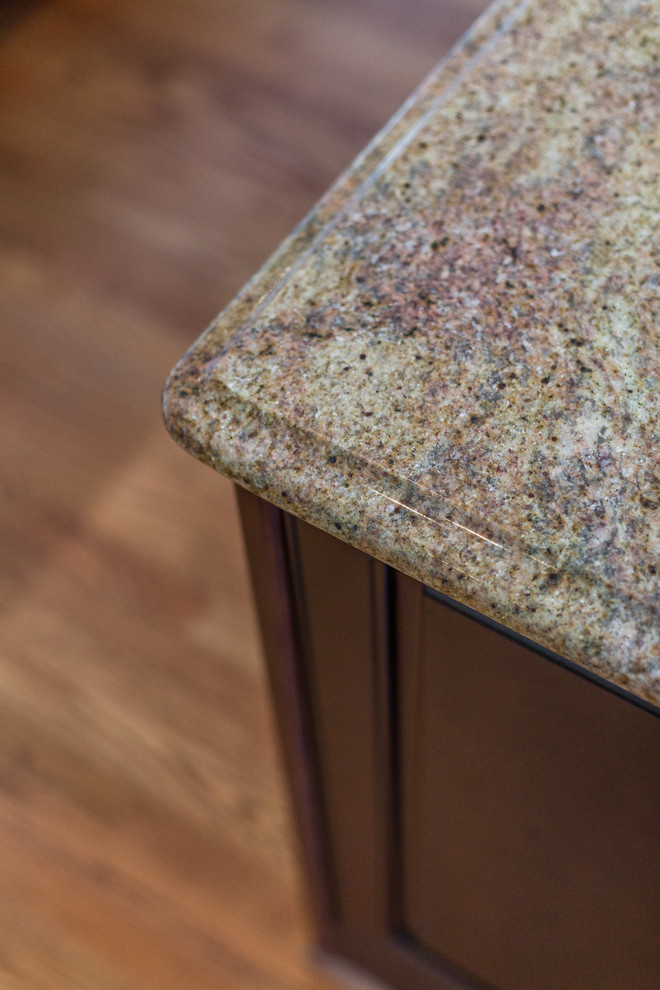 Eat-in kitchen - huge transitional medium tone wood floor eat-in kitchen idea in DC Metro with raised-panel cabinets, granite countertops, stainless steel appliances and an island