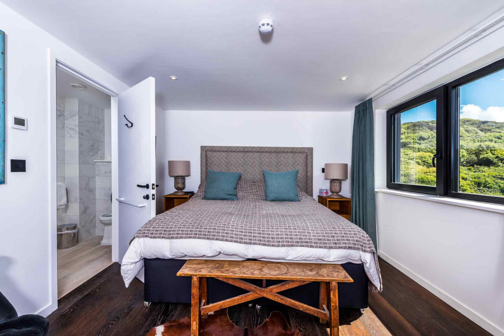 This is an example of a large rustic bedroom in Cornwall.