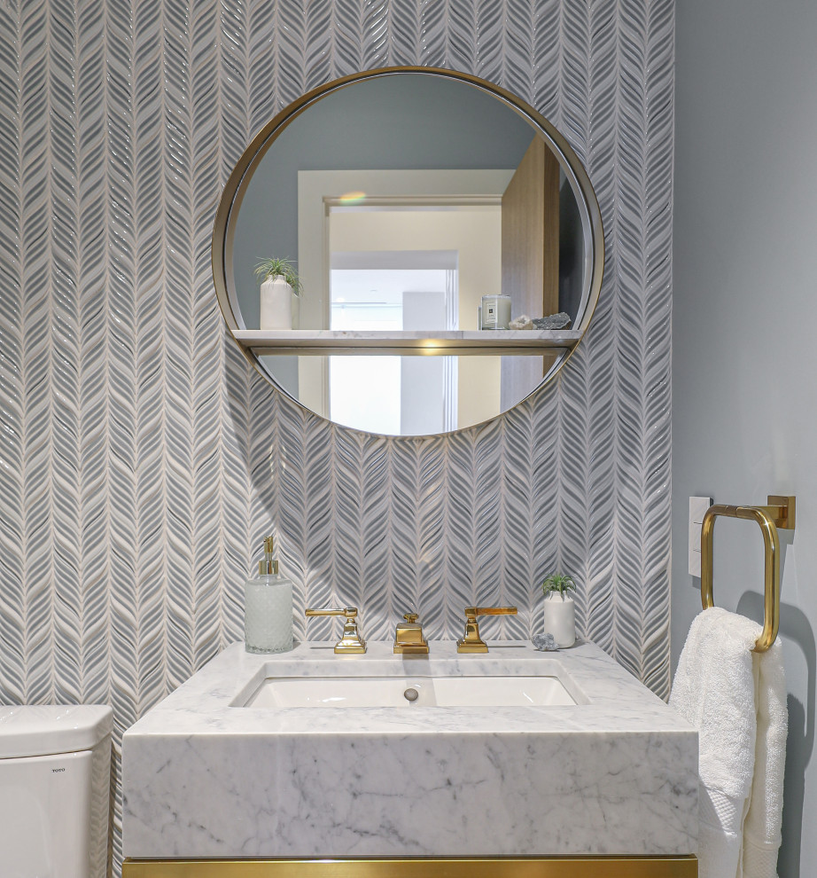 Powder room - small contemporary blue tile and mosaic tile light wood floor and white floor powder room idea in Boston with a one-piece toilet, blue walls, an undermount sink, marble countertops, gray countertops and a freestanding vanity