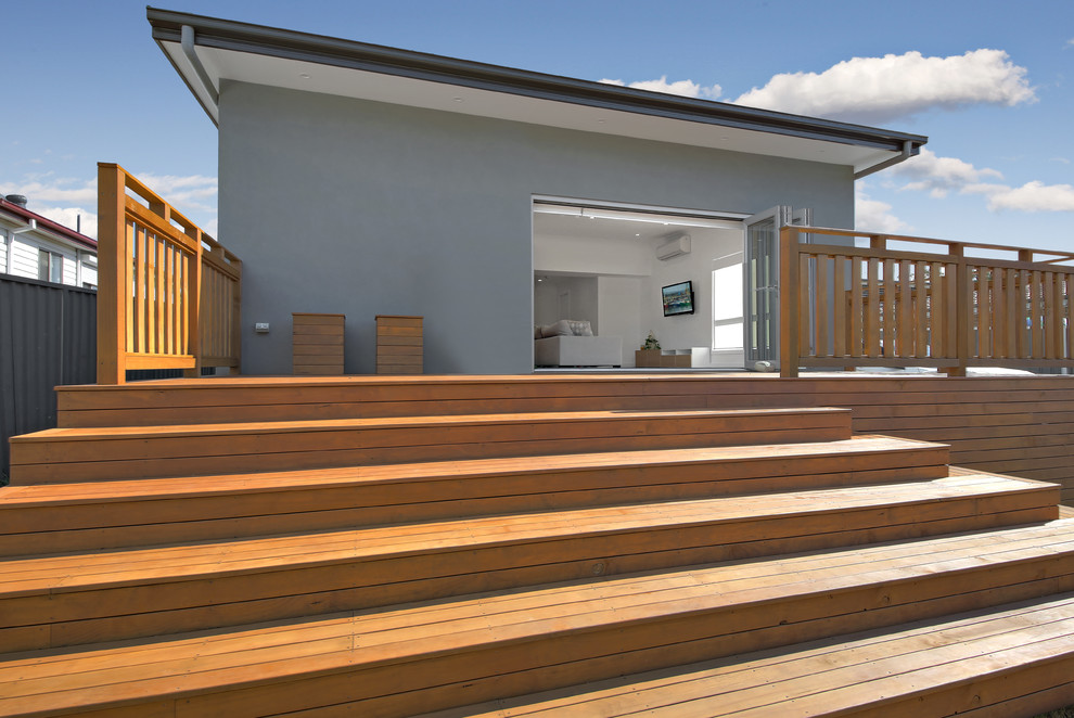 Large modern backyard deck in Sydney with no cover.