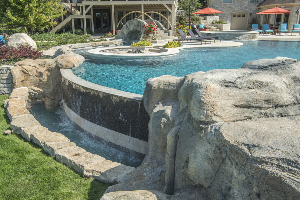 Inspiration for a huge backyard stone and custom-shaped pool fountain remodel in Chicago