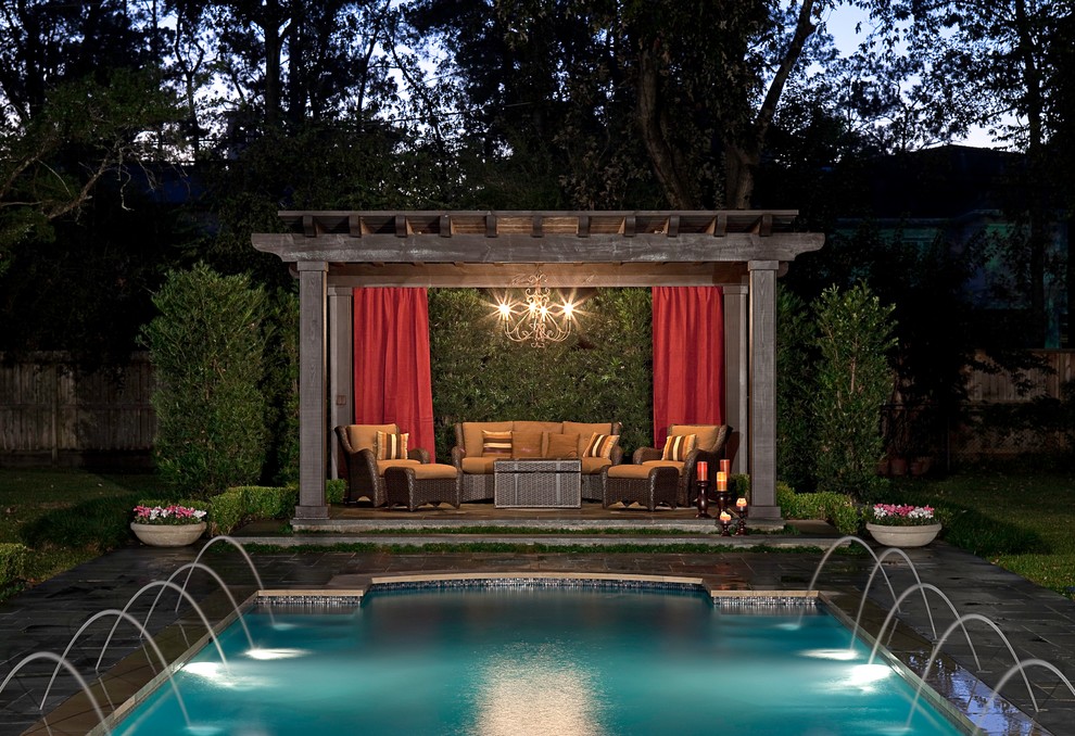 Design ideas for a traditional rectangular pool in Houston with a water feature.