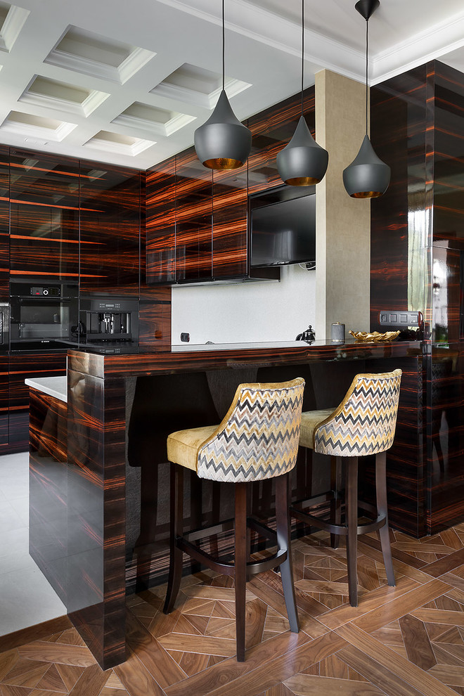 Mid-sized contemporary u-shaped open plan kitchen in Saint Petersburg with medium hardwood floors, flat-panel cabinets, dark wood cabinets, white splashback, black appliances and a peninsula.