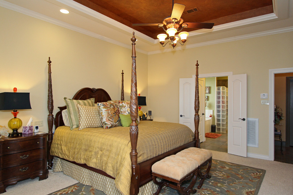 Design ideas for a large mediterranean master bedroom in Houston with blue walls, carpet and no fireplace.