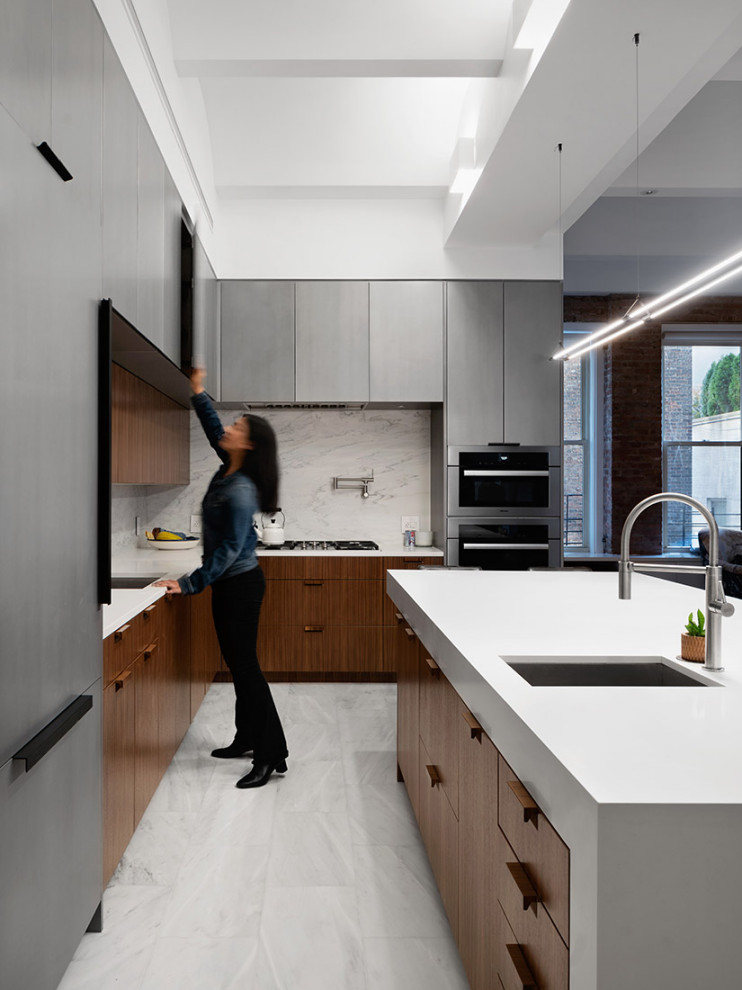 Design ideas for a large contemporary l-shaped kitchen in New York with an undermount sink, flat-panel cabinets, dark wood cabinets, quartz benchtops, white splashback, stone slab splashback, stainless steel appliances, marble floors, with island, white benchtop and white floor.