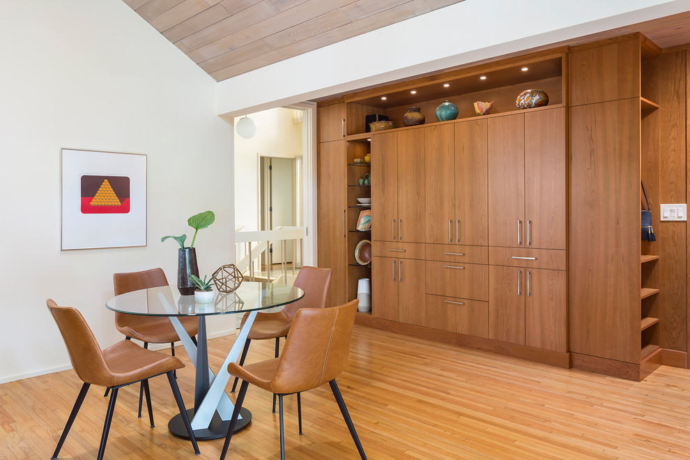 Mid-sized midcentury galley separate kitchen in Minneapolis with an integrated sink, flat-panel cabinets, brown cabinets, solid surface benchtops, stainless steel appliances, light hardwood floors, with island, brown floor and white benchtop.