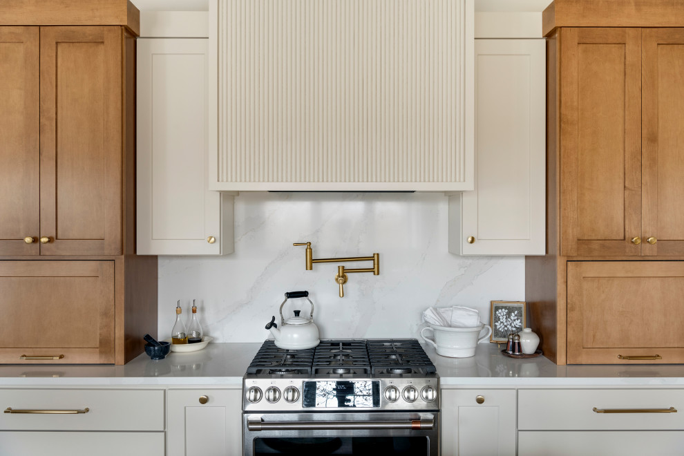 Inspiration for a mid-sized transitional galley medium tone wood floor, brown floor and vaulted ceiling eat-in kitchen remodel in Minneapolis with an undermount sink, shaker cabinets, quartz countertops, white backsplash, subway tile backsplash, stainless steel appliances, an island and white countertops