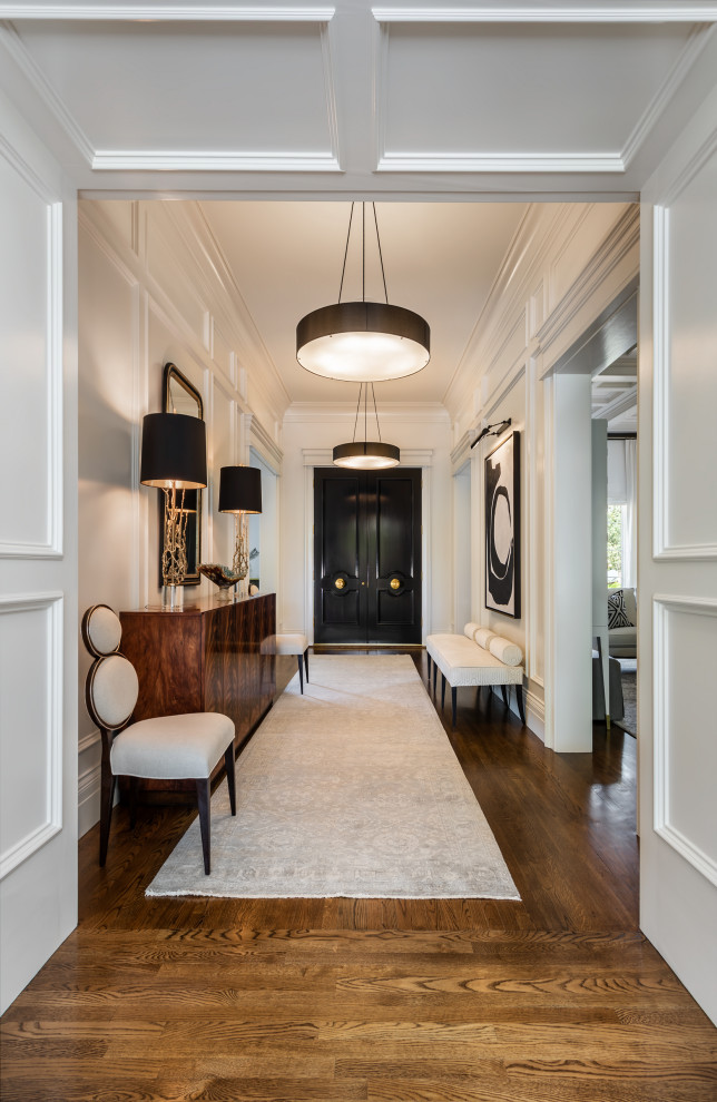 Inspiration for a mid-sized transitional foyer in Other with white walls, medium hardwood floors, a double front door, a black front door and brown floor.