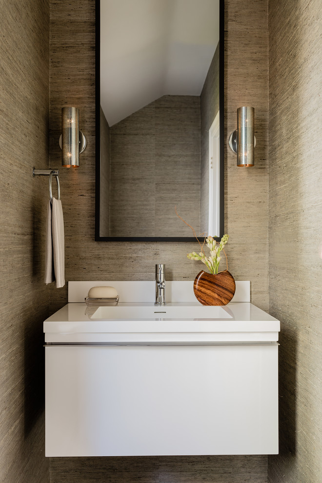 Small contemporary powder room in Boston with flat-panel cabinets, white cabinets and an integrated sink.