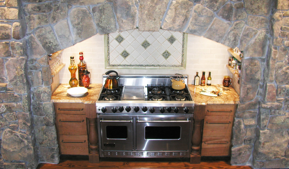 Inspiration for a large rustic l-shaped medium tone wood floor and brown floor eat-in kitchen remodel with an undermount sink, shaker cabinets, medium tone wood cabinets, granite countertops, white backsplash, ceramic backsplash, stainless steel appliances and an island