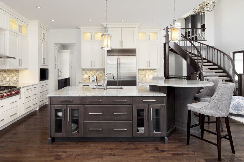 Transitional dark wood floor and brown floor kitchen photo in Calgary with an undermount sink, shaker cabinets, white cabinets, multicolored backsplash, stainless steel appliances and an island