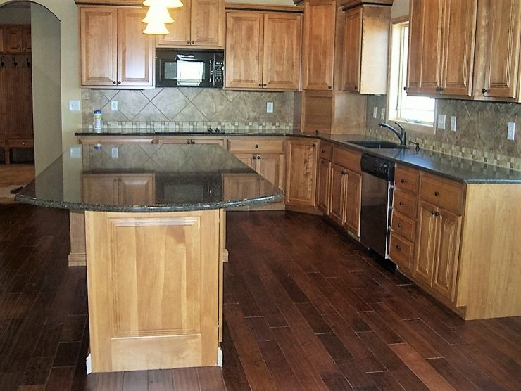 Inspiration for a large rustic l-shaped dark wood floor open concept kitchen remodel with an undermount sink, raised-panel cabinets, medium tone wood cabinets, quartz countertops, multicolored backsplash and an island
