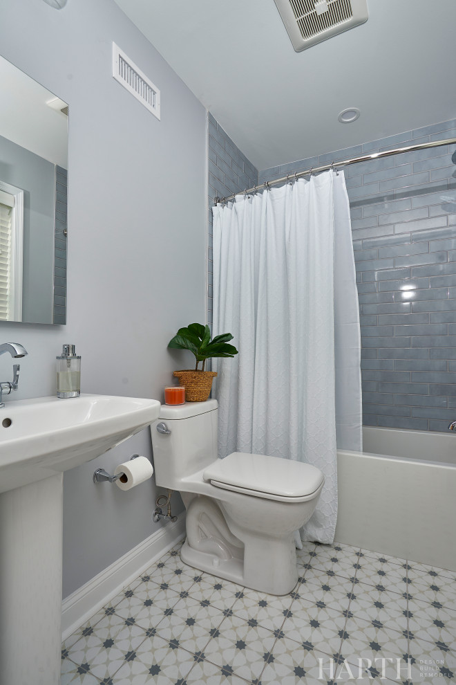 Свежая идея для дизайна: ванная комната среднего размера в стиле неоклассика (современная классика) с ванной в нише, душем над ванной, раздельным унитазом, синей плиткой, плиткой кабанчик, синими стенами, полом из цементной плитки, душевой кабиной, раковиной с пьедесталом, разноцветным полом, шторкой для ванной, нишей, тумбой под одну раковину и напольной тумбой - отличное фото интерьера
