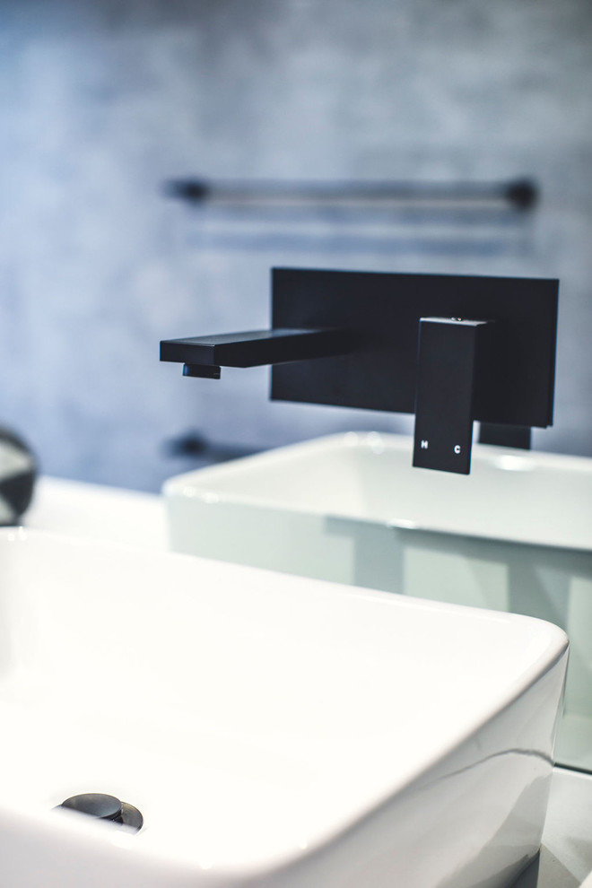 Modern wet room bathroom in Perth with beaded inset cabinets, black cabinets, a freestanding tub, a one-piece toilet, multi-coloured tile, mirror tile, grey walls, ceramic floors, a vessel sink, engineered quartz benchtops, grey floor, an open shower and white benchtops.