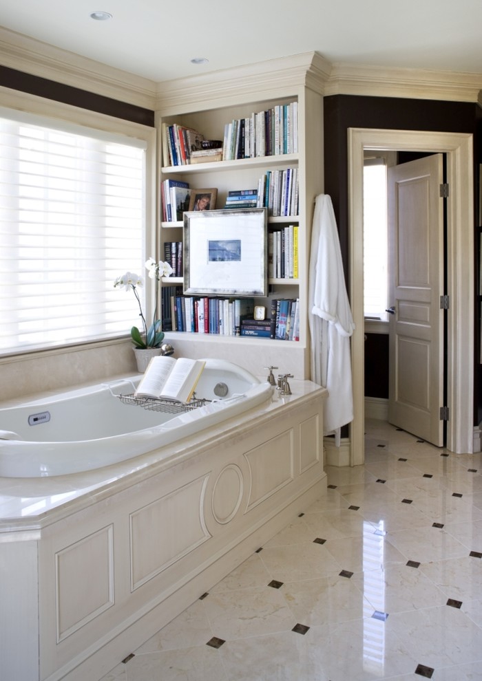 Design ideas for a traditional bathroom in DC Metro with a drop-in tub, beige tile and marble floors.