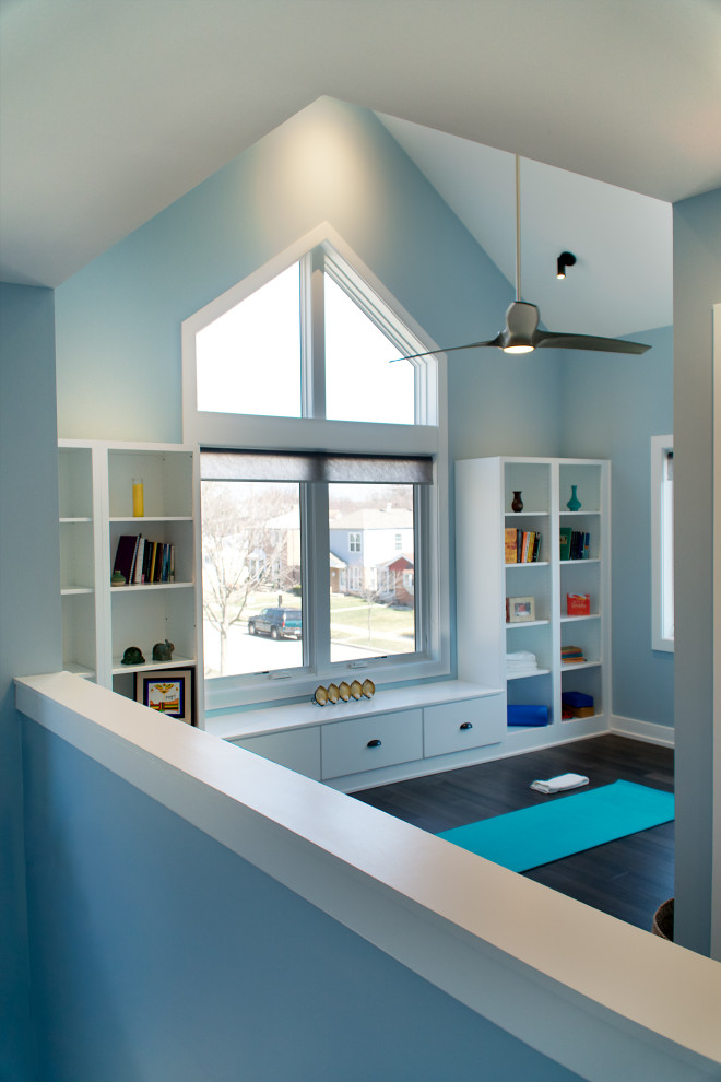 Inspiration for a mid-sized modern home gym in Chicago with blue walls, dark hardwood floors, brown floor and vaulted.
