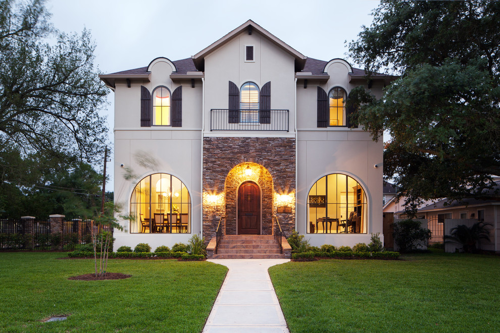 Photo of a transitional two-storey beige exterior in Houston.