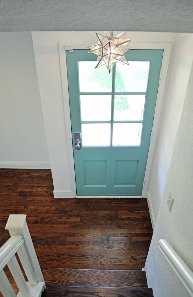 Small country front door in Dallas with white walls, medium hardwood floors, a single front door, a blue front door and brown floor.