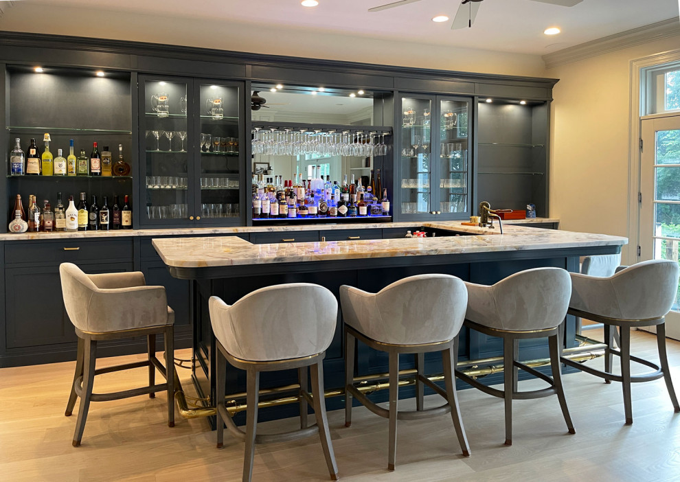 Seated home bar - large transitional single-wall light wood floor and brown floor seated home bar idea in New York with an integrated sink, shaker cabinets, black cabinets, quartz countertops, blue backsplash, quartz backsplash and blue countertops