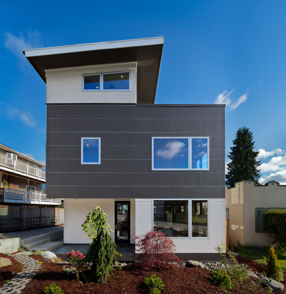 This is an example of a contemporary three-storey exterior in Seattle with mixed siding.