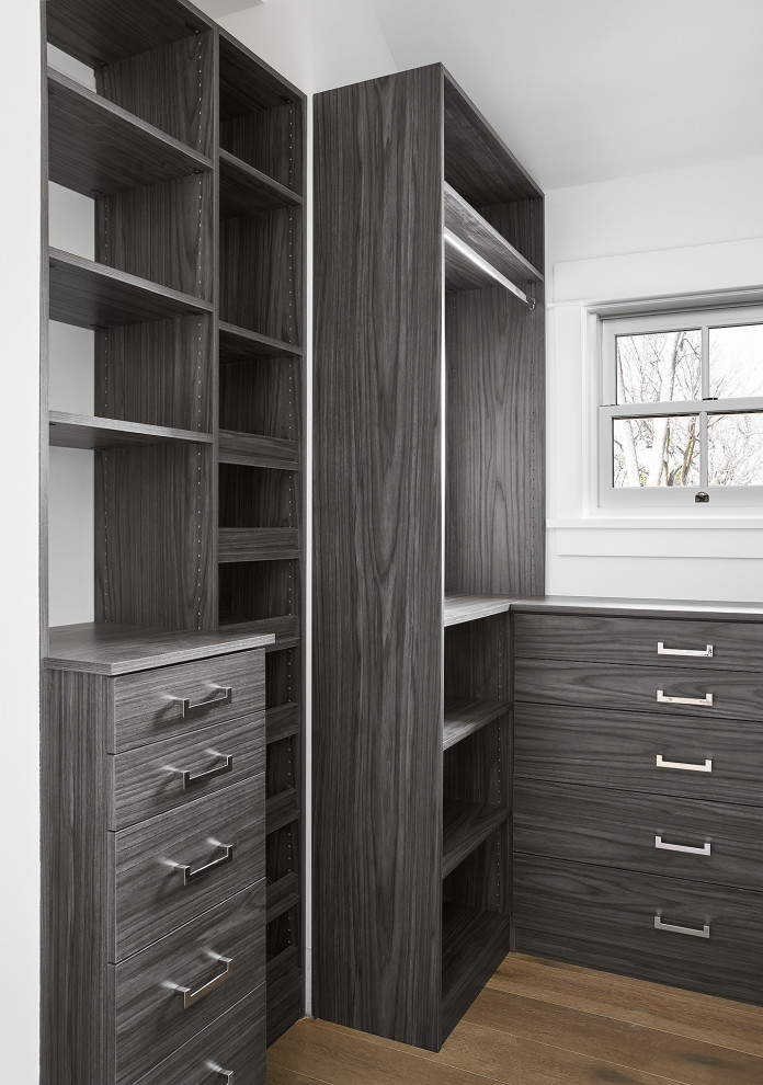 Medium sized contemporary walk-in wardrobe for men in Other with flat-panel cabinets, grey cabinets, light hardwood flooring and beige floors.