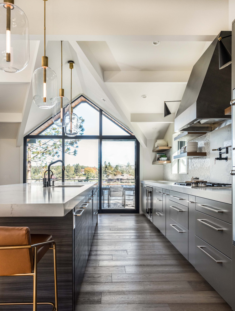 Inspiration for a large contemporary galley open plan kitchen in Sacramento with an undermount sink, flat-panel cabinets, grey cabinets, quartz benchtops, white splashback, marble splashback, panelled appliances, medium hardwood floors, with island, brown floor, white benchtop and exposed beam.