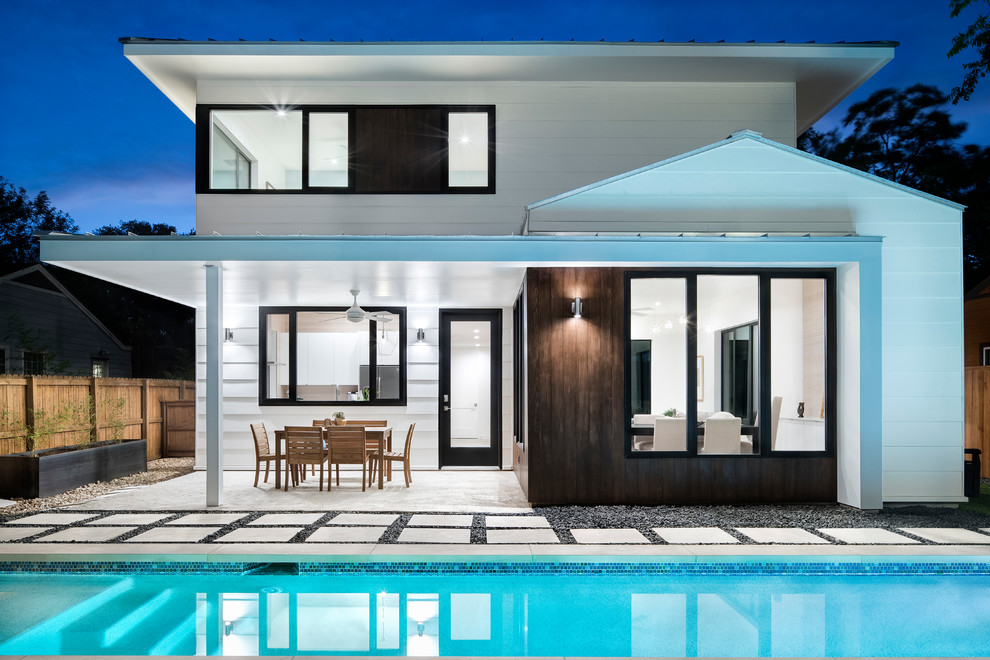 Pool - small transitional backyard stone and rectangular pool idea in Austin