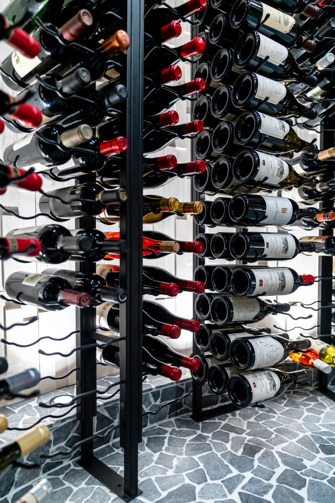 Large contemporary wine cellar in Columbus with display racks.