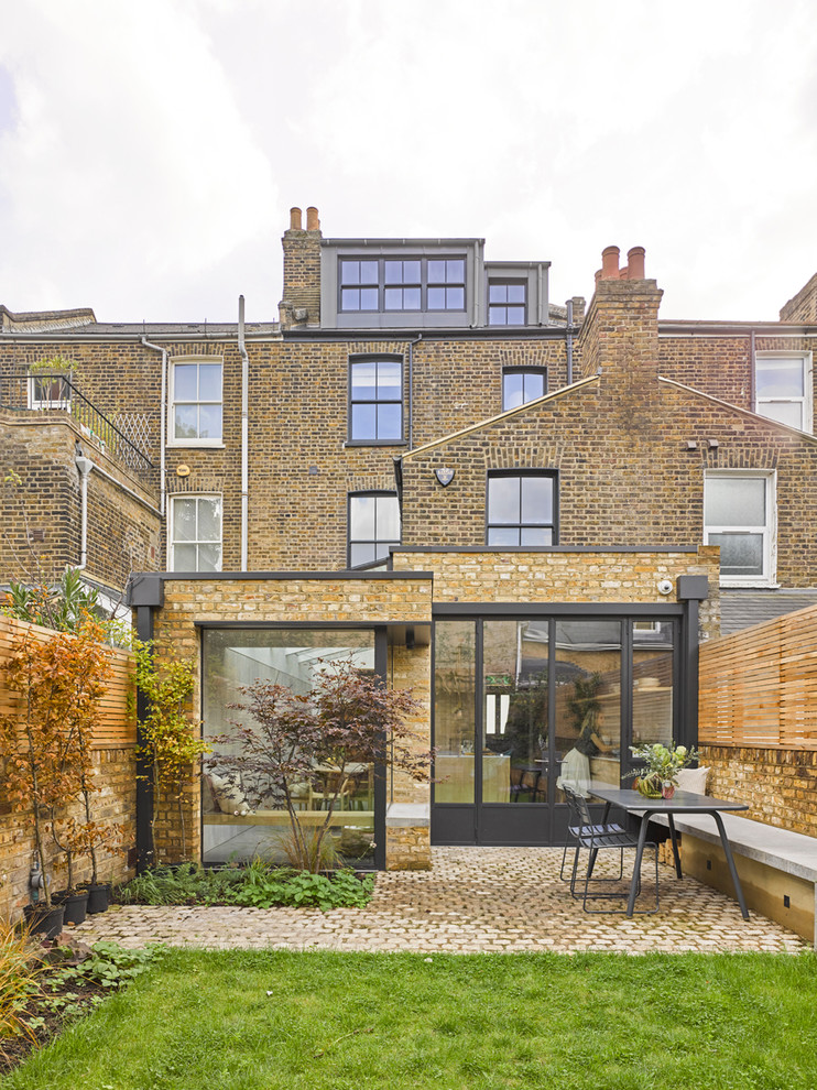 Inspiration for a mid-sized contemporary brick townhouse exterior in London.