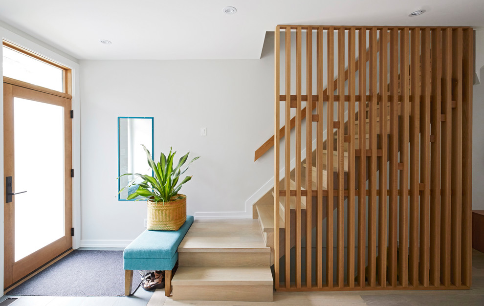 Photo of a mid-sized contemporary wood floating staircase in Toronto with wood risers and wood railing.
