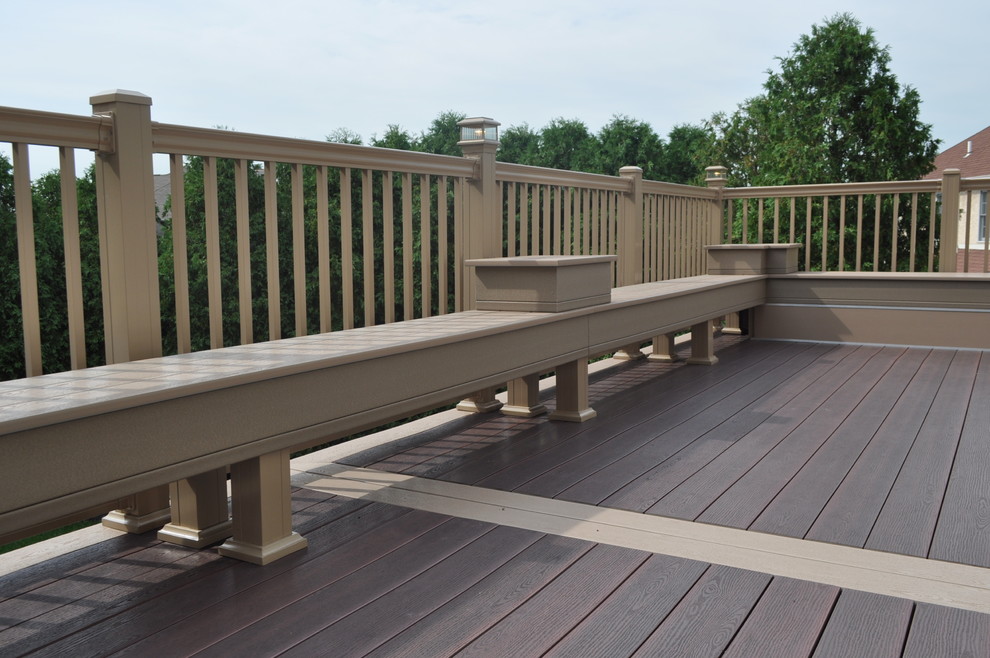 Example of a mid-sized transitional backyard deck design with no cover
