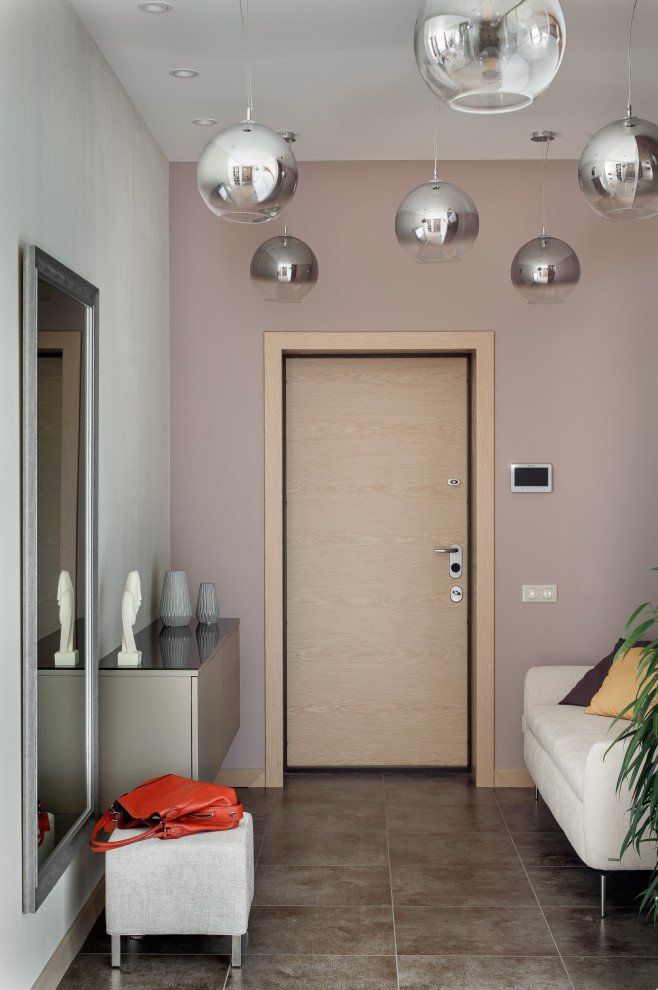 This is an example of a mid-sized contemporary front door in Other with multi-coloured walls, porcelain floors, a single front door, a medium wood front door and brown floor.