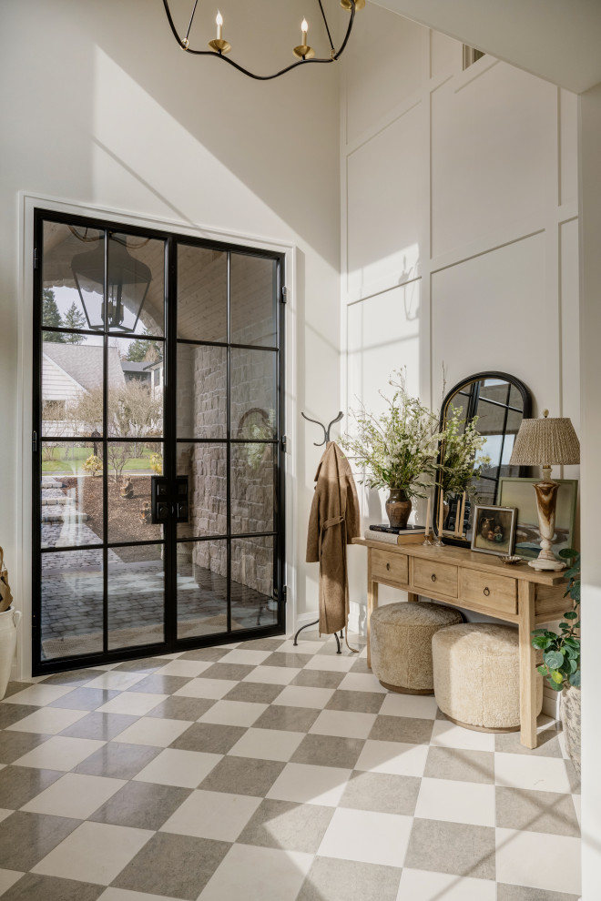 Inspiration for a transitional wall paneling and multicolored floor entryway remodel in Seattle with beige walls and a glass front door