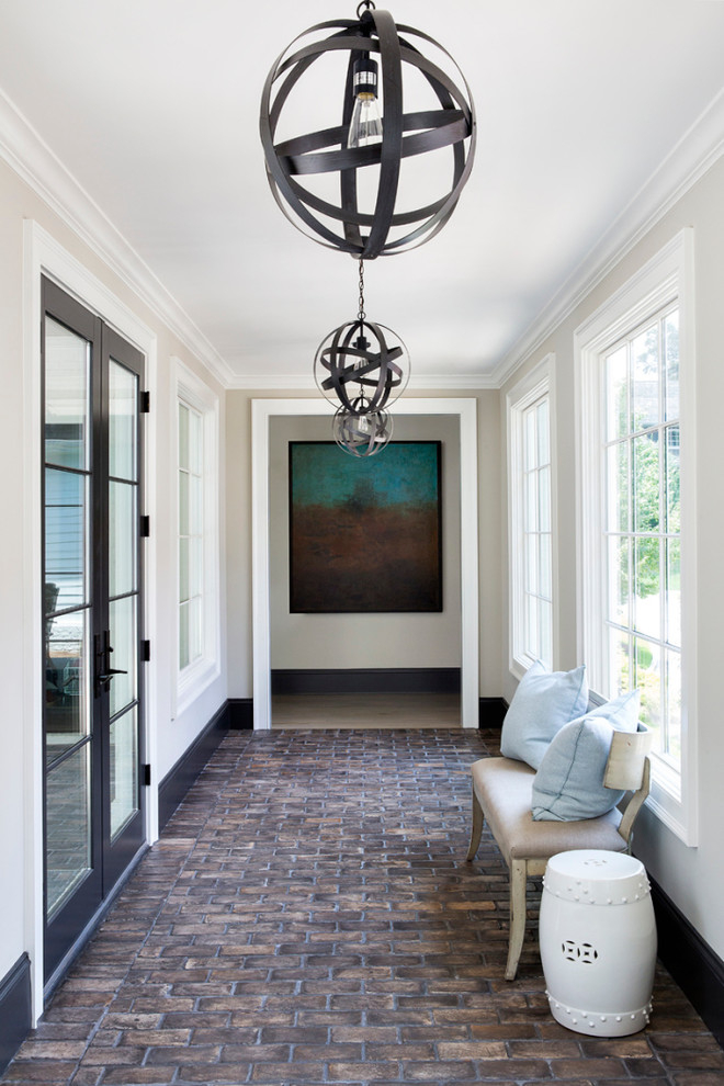 Inspiration for a large transitional hallway in Atlanta with grey walls and brick floors.