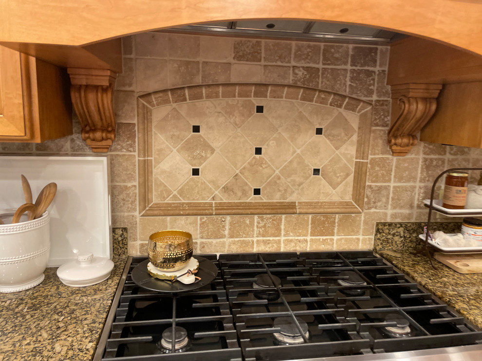 Example of a transitional medium tone wood floor kitchen design in Indianapolis with an undermount sink, medium tone wood cabinets, quartzite countertops, white backsplash, ceramic backsplash, an island and beige countertops