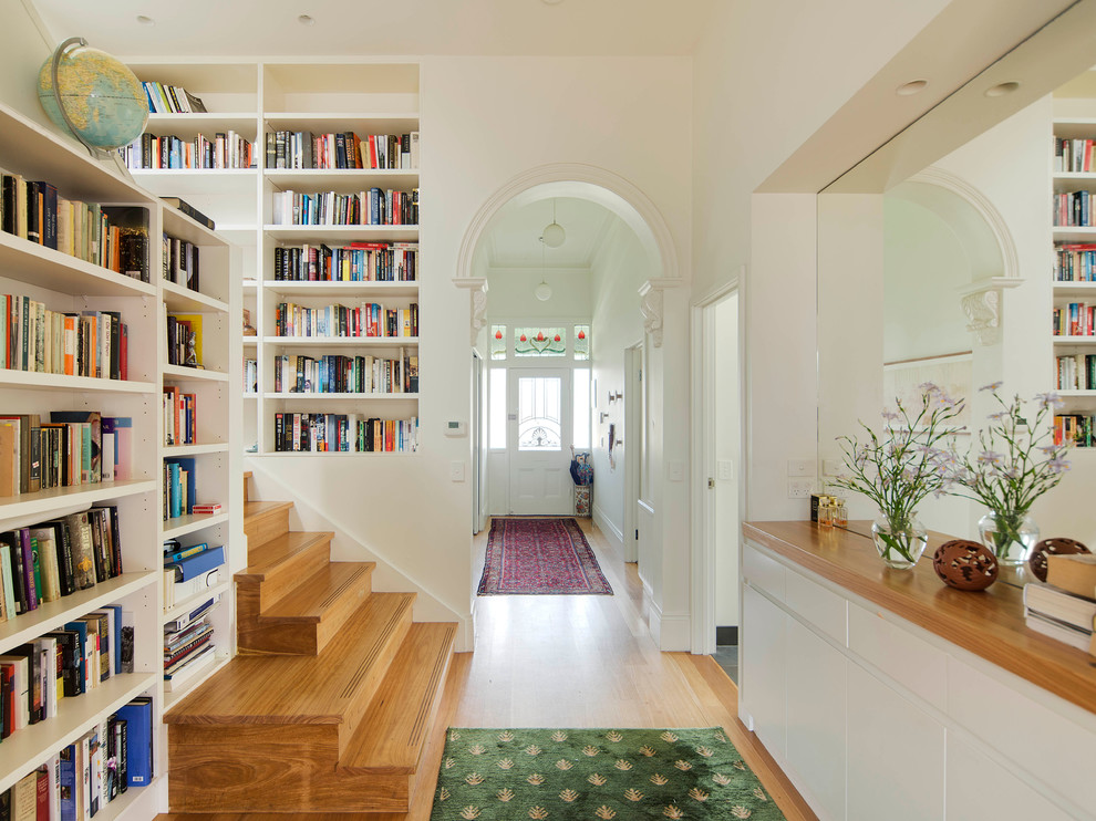 Photo of a mid-sized traditional wood u-shaped staircase in Melbourne with white walls, medium hardwood floors and wood risers.