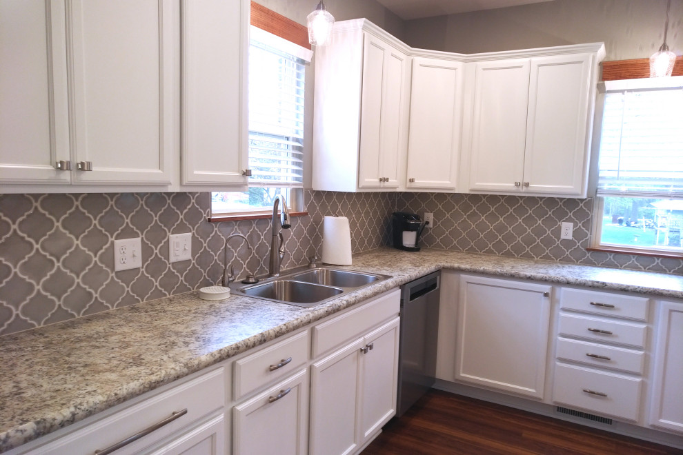 Mid-sized u-shaped vinyl floor and brown floor eat-in kitchen photo with a drop-in sink, shaker cabinets, white cabinets, laminate countertops, porcelain backsplash, stainless steel appliances, no island and brown countertops