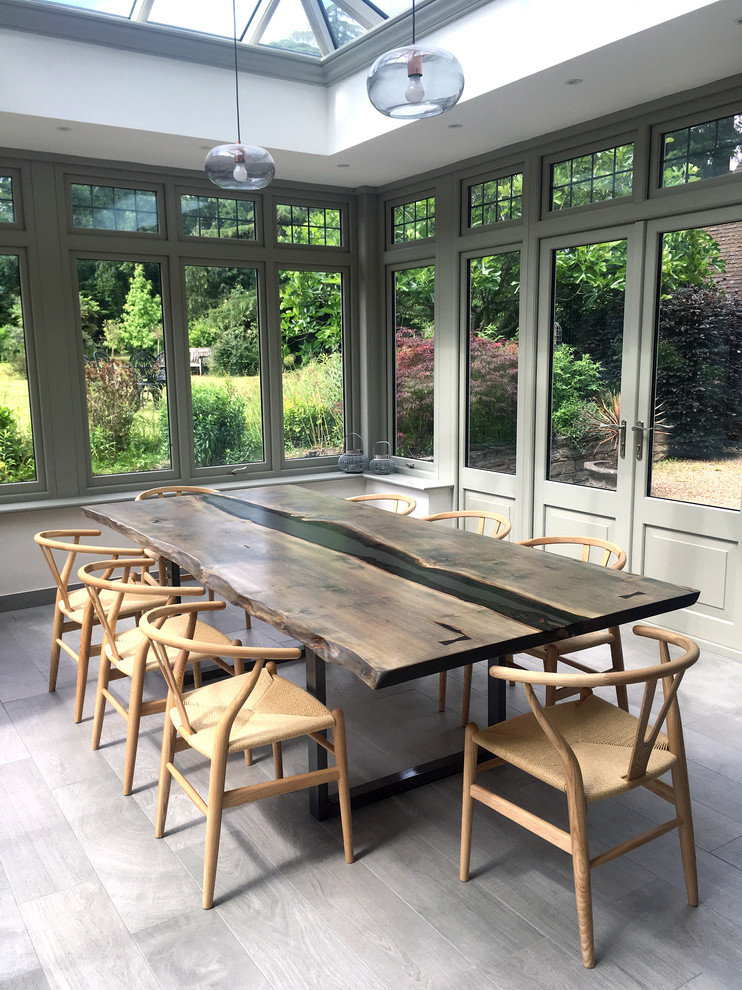 Inspiration for a contemporary dining room in Sussex with grey floor.