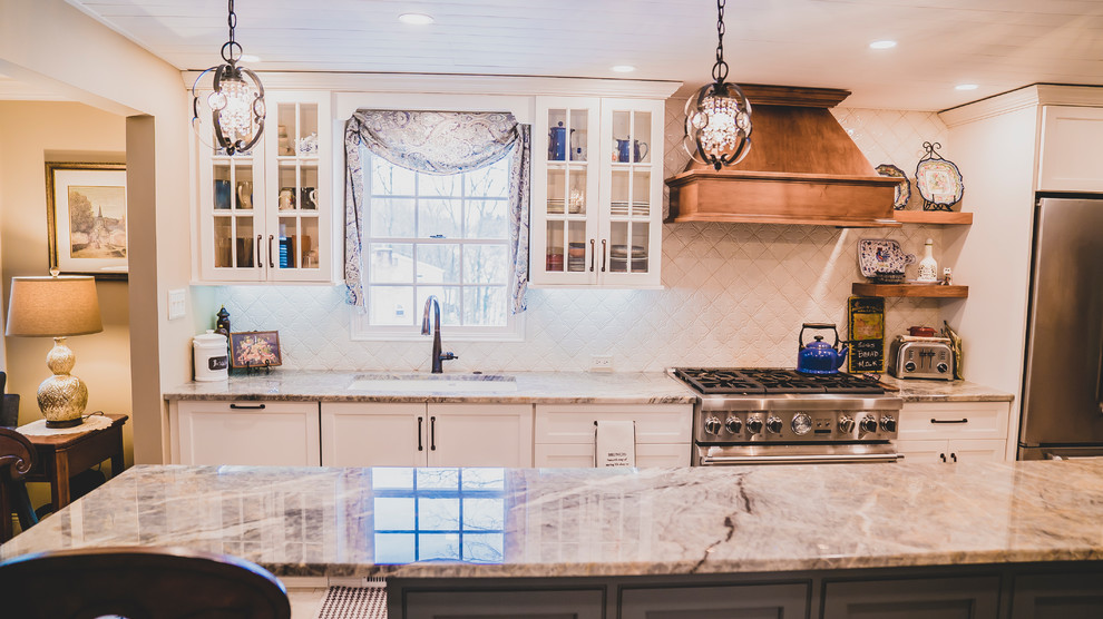 Inspiration for a mid-sized transitional porcelain tile and beige floor eat-in kitchen remodel with an undermount sink, shaker cabinets, white cabinets, quartzite countertops, ceramic backsplash, stainless steel appliances, an island, multicolored countertops and white backsplash