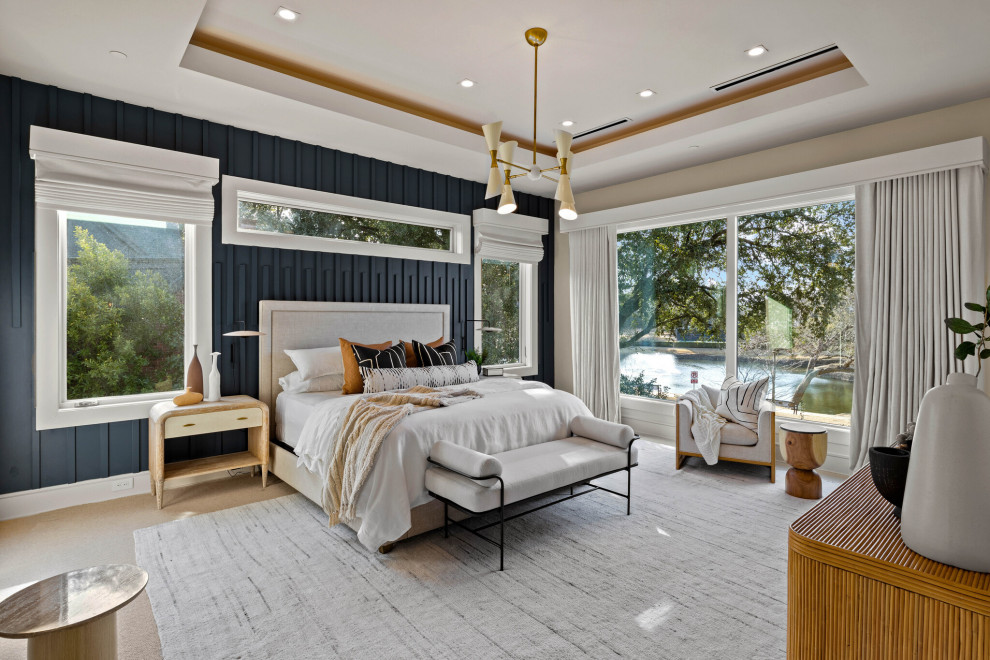 Large contemporary guest bedroom in Dallas with white walls, carpet, beige floors and wood walls.