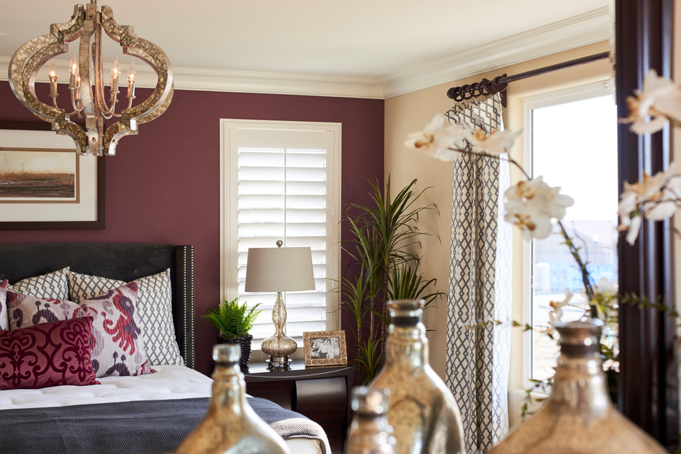 Example of a transitional bedroom design with purple walls