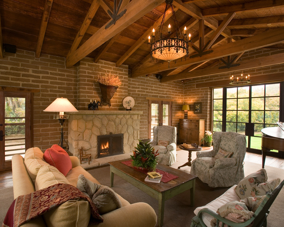 Design ideas for a large open concept family room in Santa Barbara with a standard fireplace, a stone fireplace surround, no tv and medium hardwood floors.