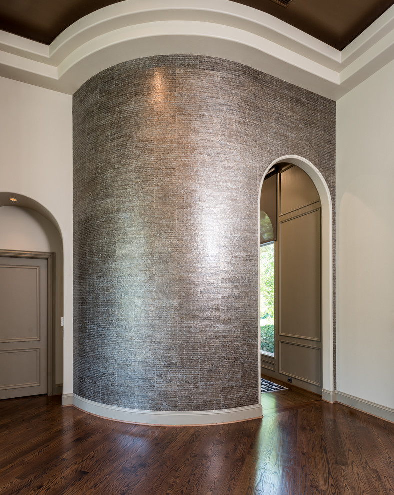 This is an example of a large contemporary foyer in Dallas with metallic walls and medium hardwood floors.
