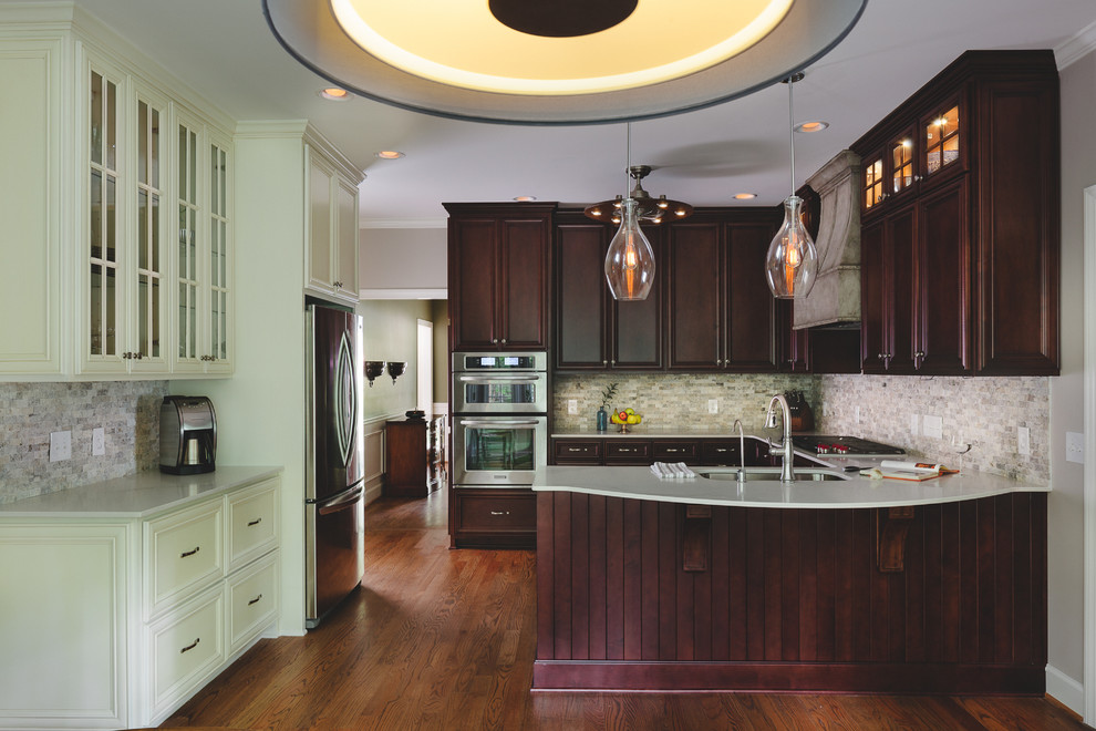 Large transitional u-shaped medium tone wood floor eat-in kitchen photo in Atlanta with an undermount sink, raised-panel cabinets, dark wood cabinets, quartz countertops, gray backsplash, stone tile backsplash, stainless steel appliances and no island